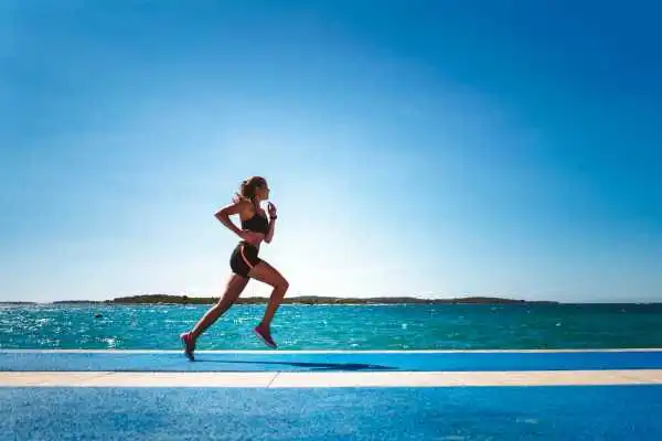 Woman running showing strong leg muscle Oxfordshire